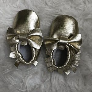 Never worn gold moccasins with bows